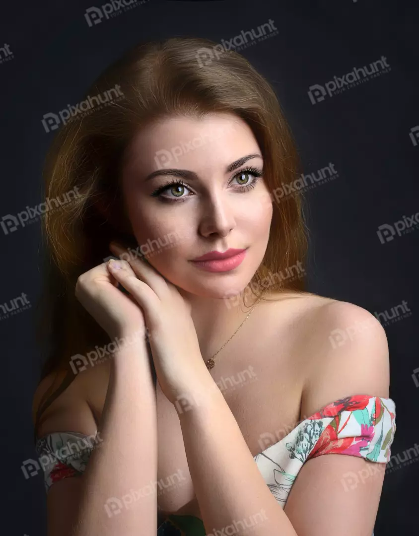 Pensive Young Woman in Off-Shoulder Floral Dress with Green Eyes