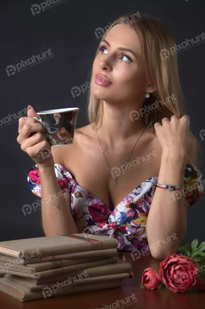 Blonde Woman in Floral Dress Savoring Tea, Contemplative Gaze Portrait