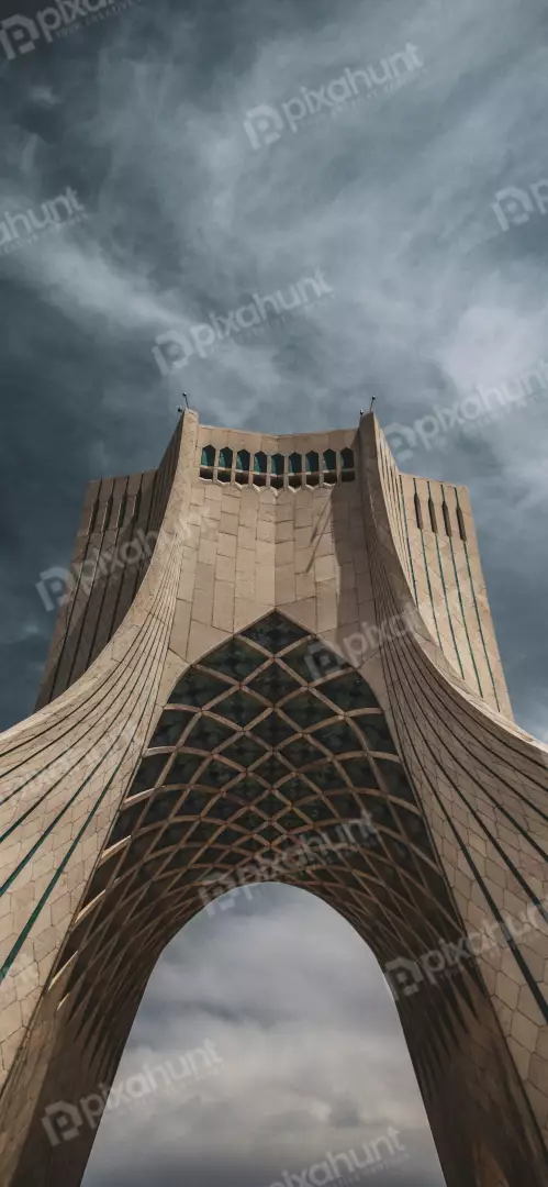 Free Premium Stock Photos Azadi Tower architecture against dramatic cloudy sky in Tehran, Iran