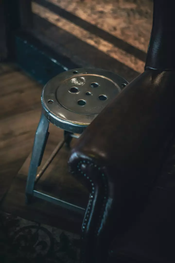 Free Premium Stock Photos Vintage industrial stool next to a leather chair