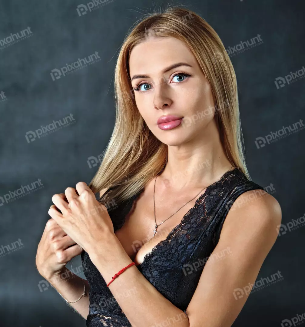 Elegant Blonde Woman in Black Lace Top with Cross Necklace