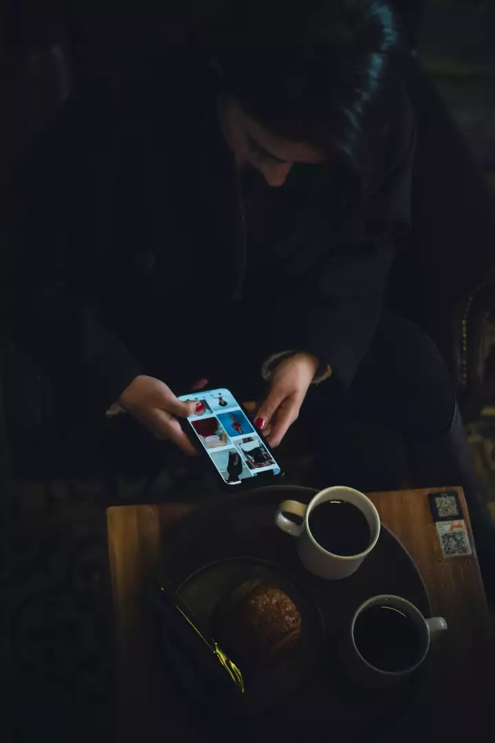 Free Premium Stock Photos Woman browsing fashion on smartphone with coffee and pastry