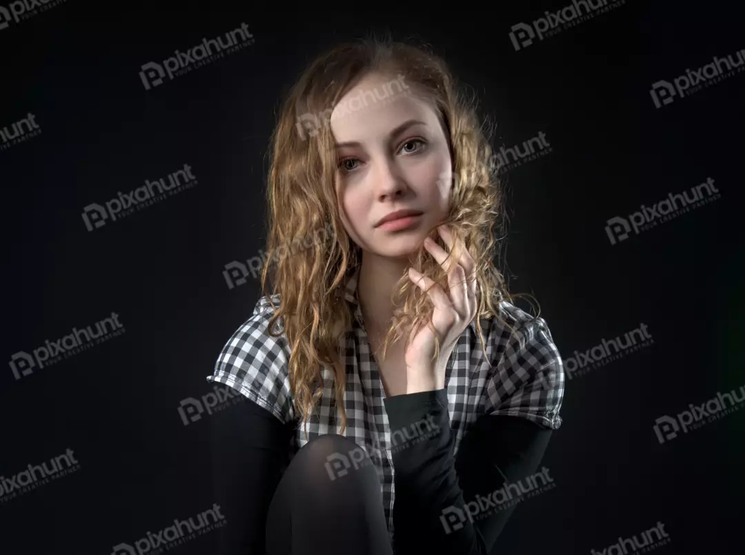 Studio Portrait of Young Woman with Wavy Hair in Plaid