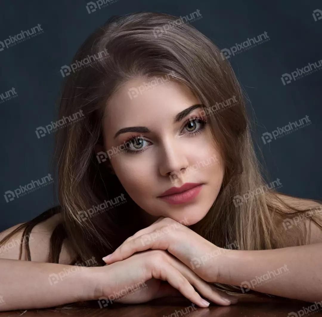 Young Woman Direct Gaze, Hands Clasped on Table Portrait