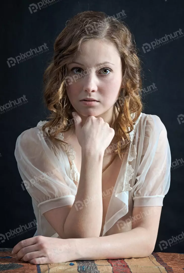 Pensive Young Woman with Reflective Gaze in Elegant Sheer Blouse Portrait