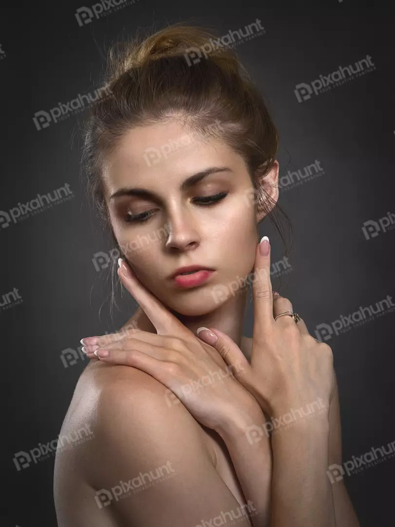 Serene Beauty Portrait: Young Woman with Closed Eyes and Elegant Hand Gesture