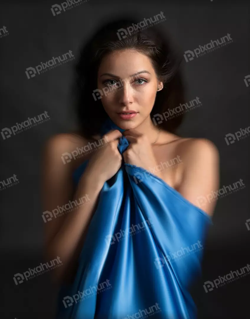 Elegant Woman with Blue Silk Draping, Dynamic Studio Portrait