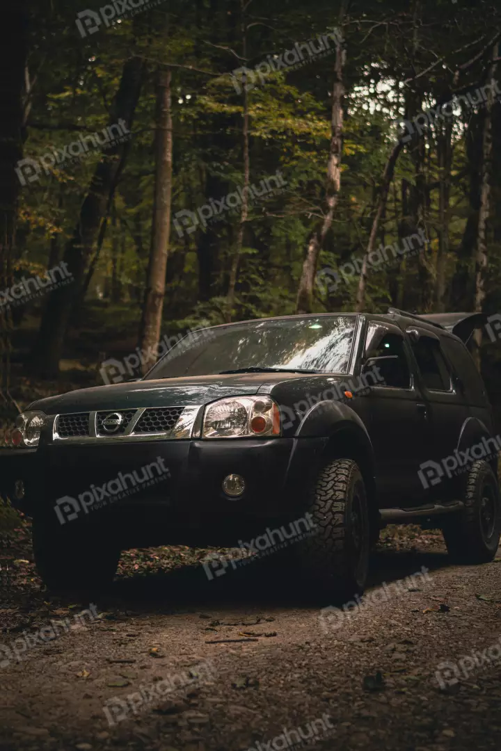 Free Premium Stock Photos Dark Green Off-Road Vehicle Navigating a Woodland Track in Deep Forest
