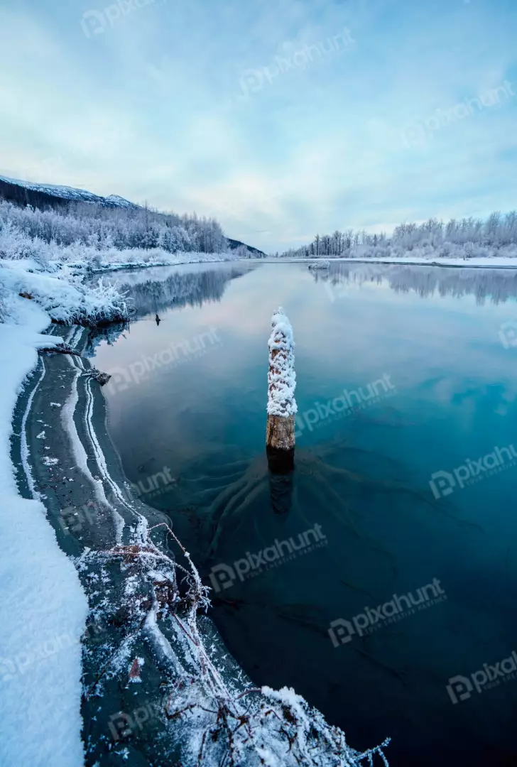 Free Premium Stock Photos Tranquil Winter River Scene with Snowy Banks and Frozen Log
