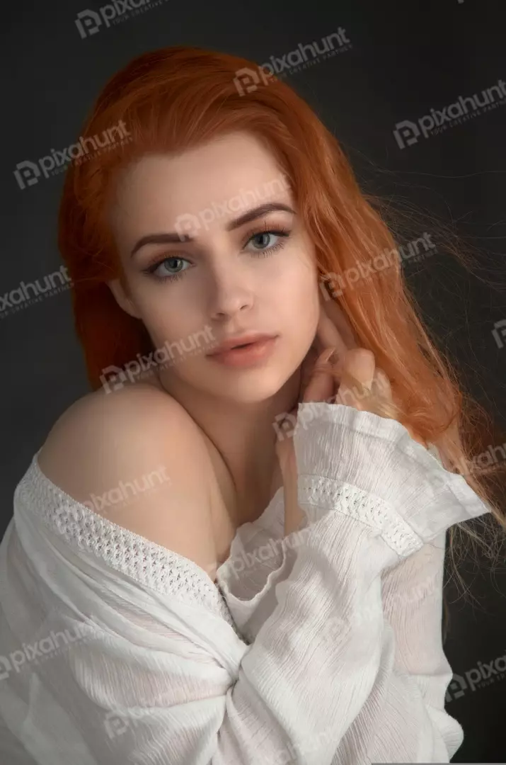 Captivating Redhead Woman with Blue-Green Eyes and Off-Shoulder Top