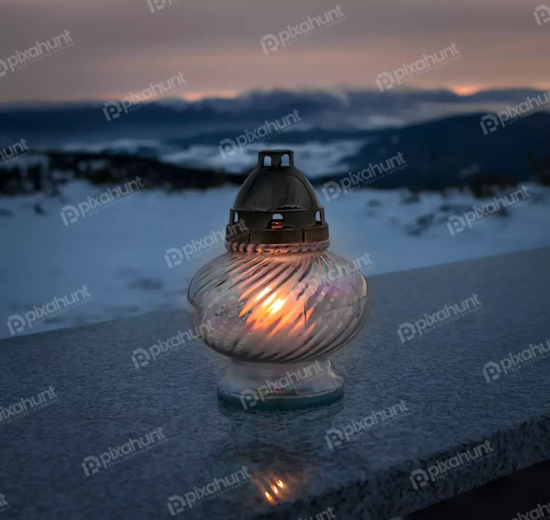 Glowing Grave Lantern on Snowy Mountain Landscape at Twilight