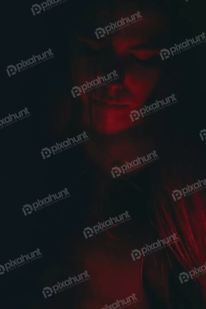 Free Premium Stock Photos Mesmerizing female portrait illuminated by vibrant red glow and deep shadows 5982