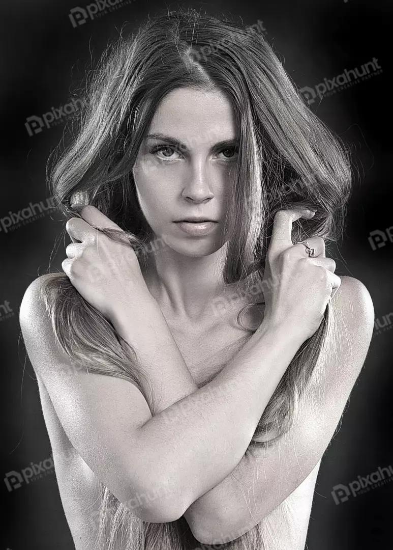 Captivating Black and White Studio Portrait of a Young Woman with Crossed Arms