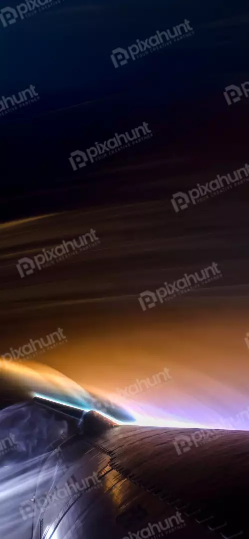 Free Premium Stock Photos Spectacular low angle view of a spaceship wing with purple and gold exhaust trails