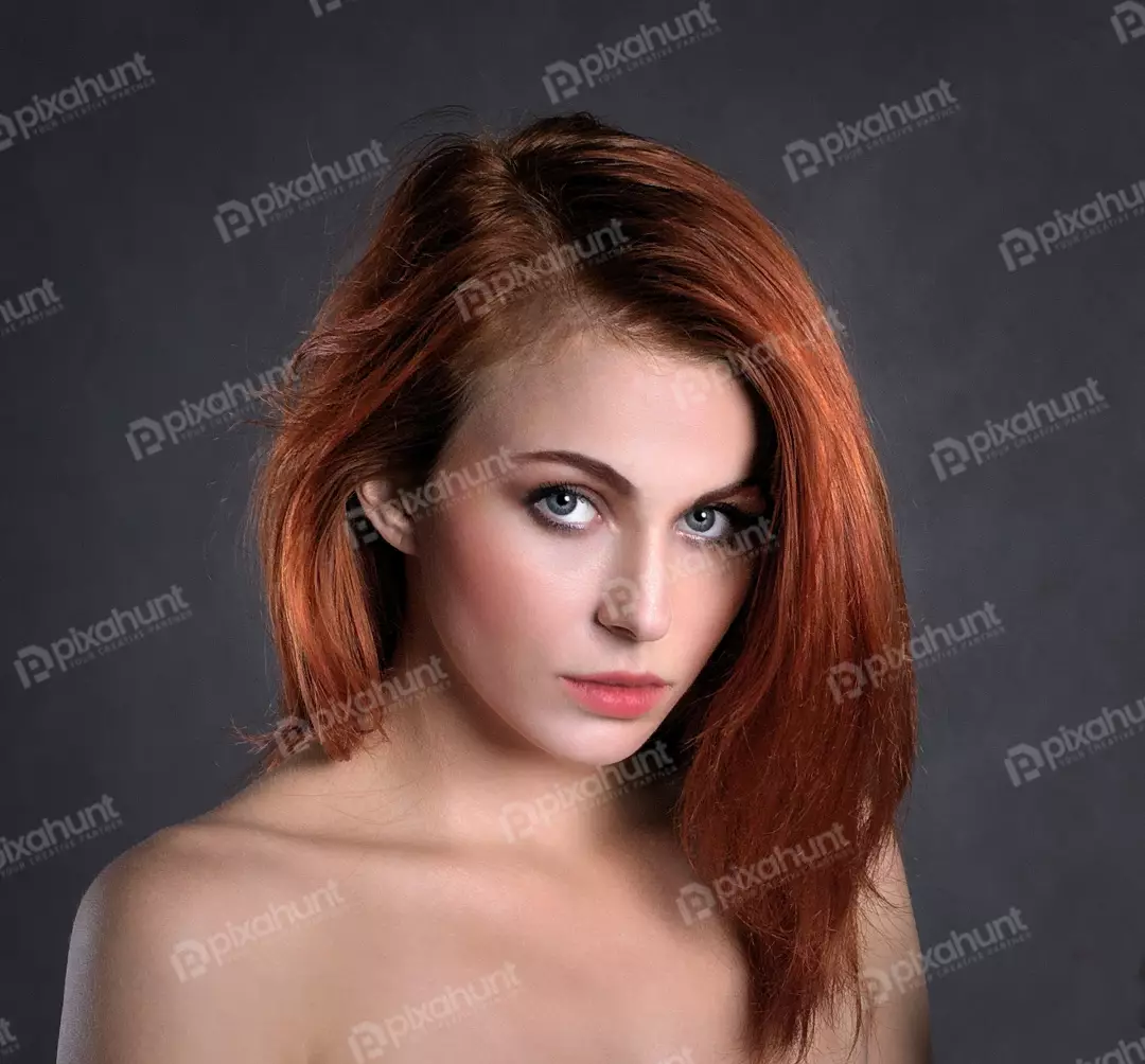 Captivating Young Woman with Fiery Red Hair and Piercing Blue Eyes
