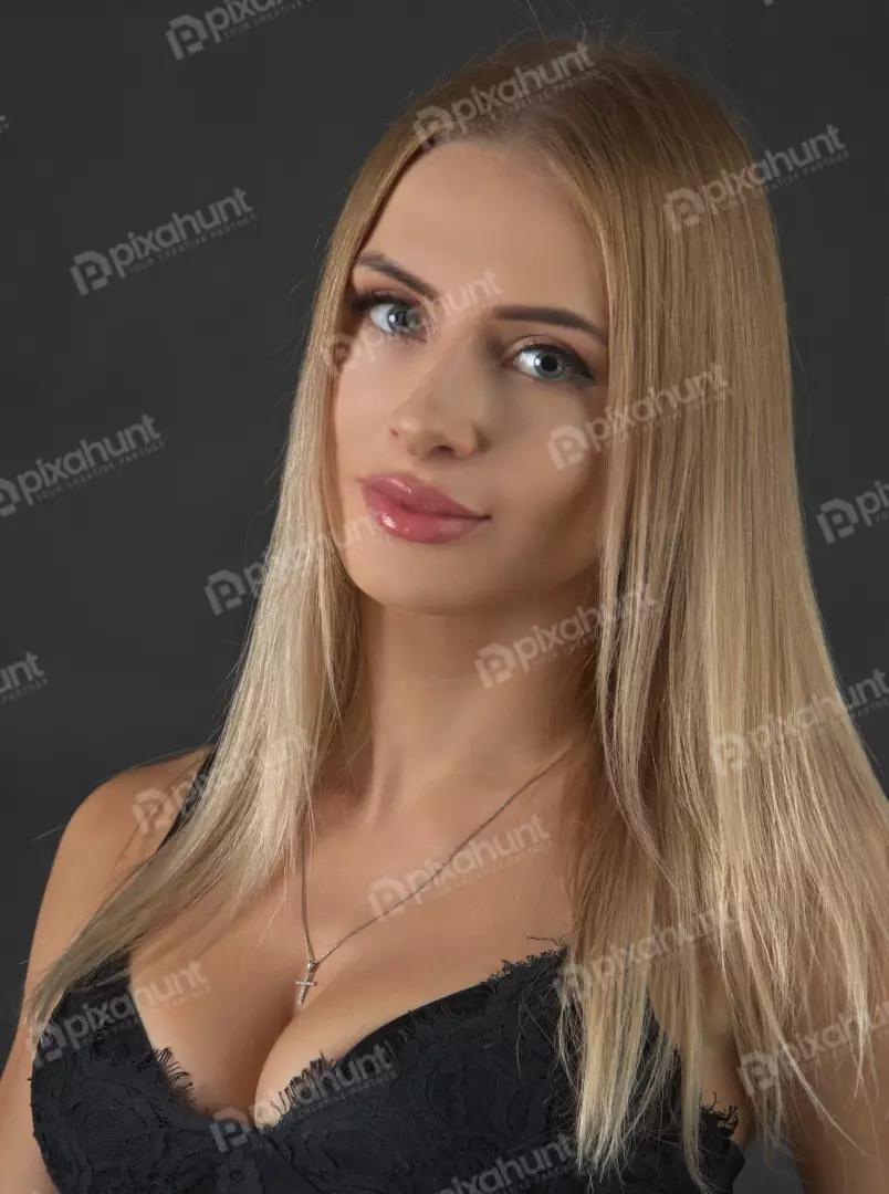 Captivating Blonde Woman in Black Lace Top with Cross Necklace