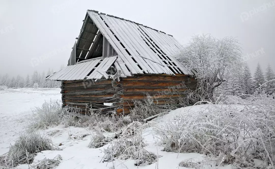 Abandoned Snowy Wooden Cabin in Winter Forest Landscape with Hoarfrost