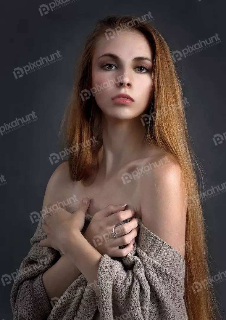 Young Woman with Long Red Hair in Knitted Sweater Studio Portrait