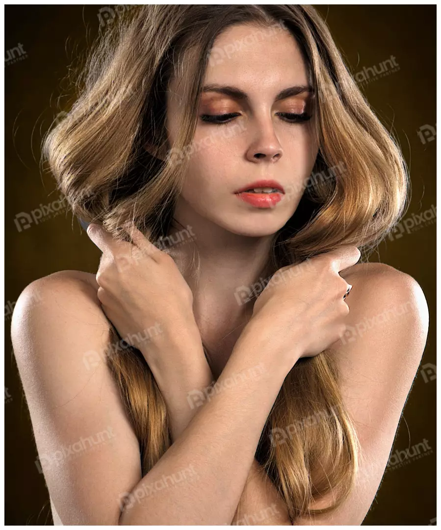 Beautiful Young Woman with Long Wavy Hair and Natural Beauty Posing Serene