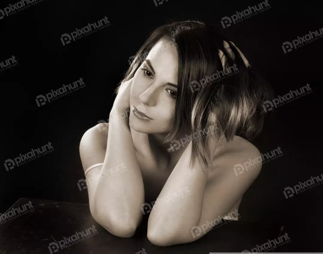Thoughtful Woman with Short Wavy Hair and Hands to Head Sepia Studio Portrait