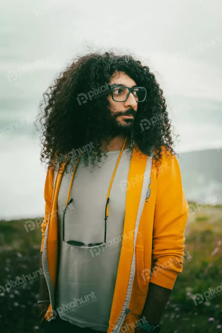 Free Premium Stock Photos Man with Curly Hair and Yellow Hoodie Outdoors
