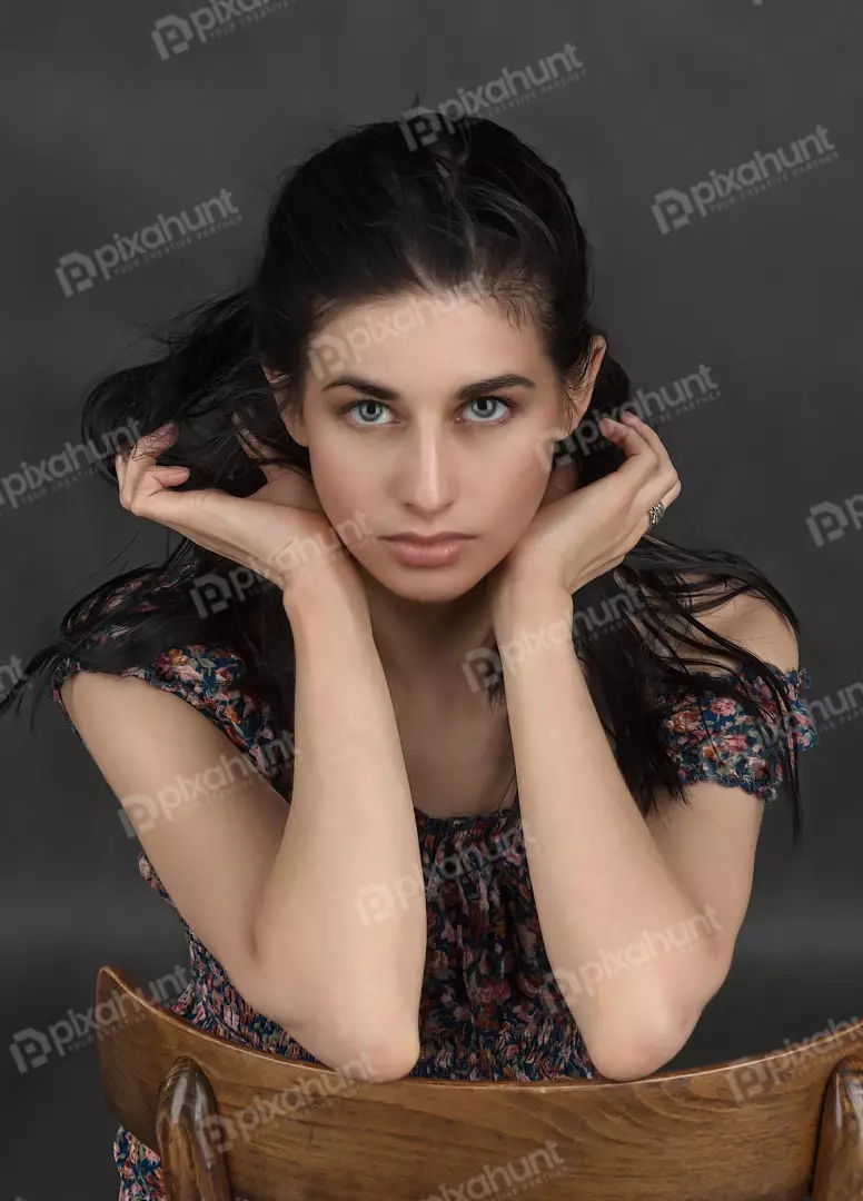 Captivating Young Woman with Striking Blue-Green Eyes in Floral Dress