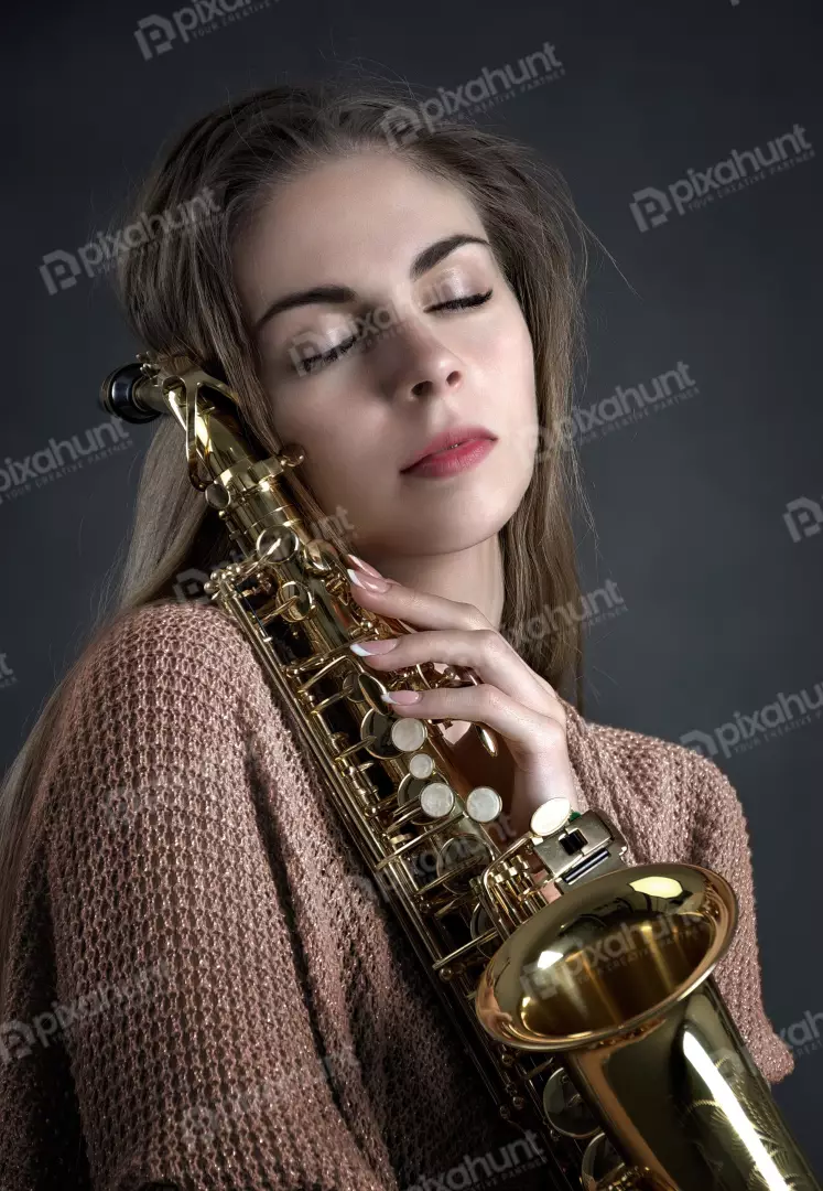 Elegant woman with closed eyes holding golden saxophone, a moment of musical serenity