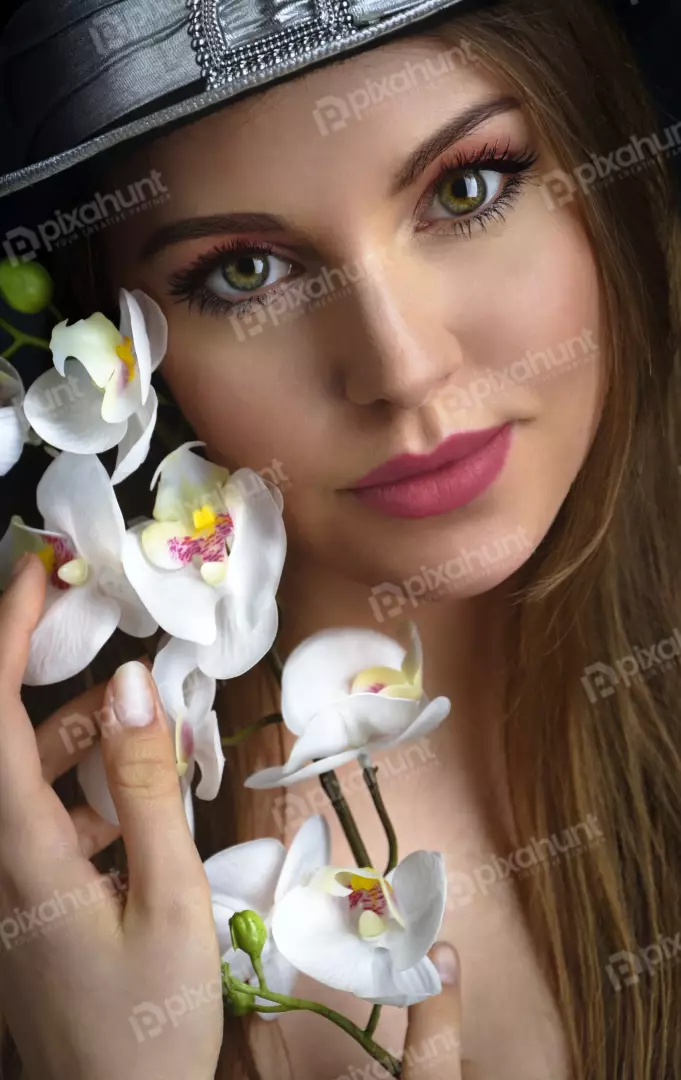 Elegant Woman in Stylish Hat with Delicate White Orchids Portrait