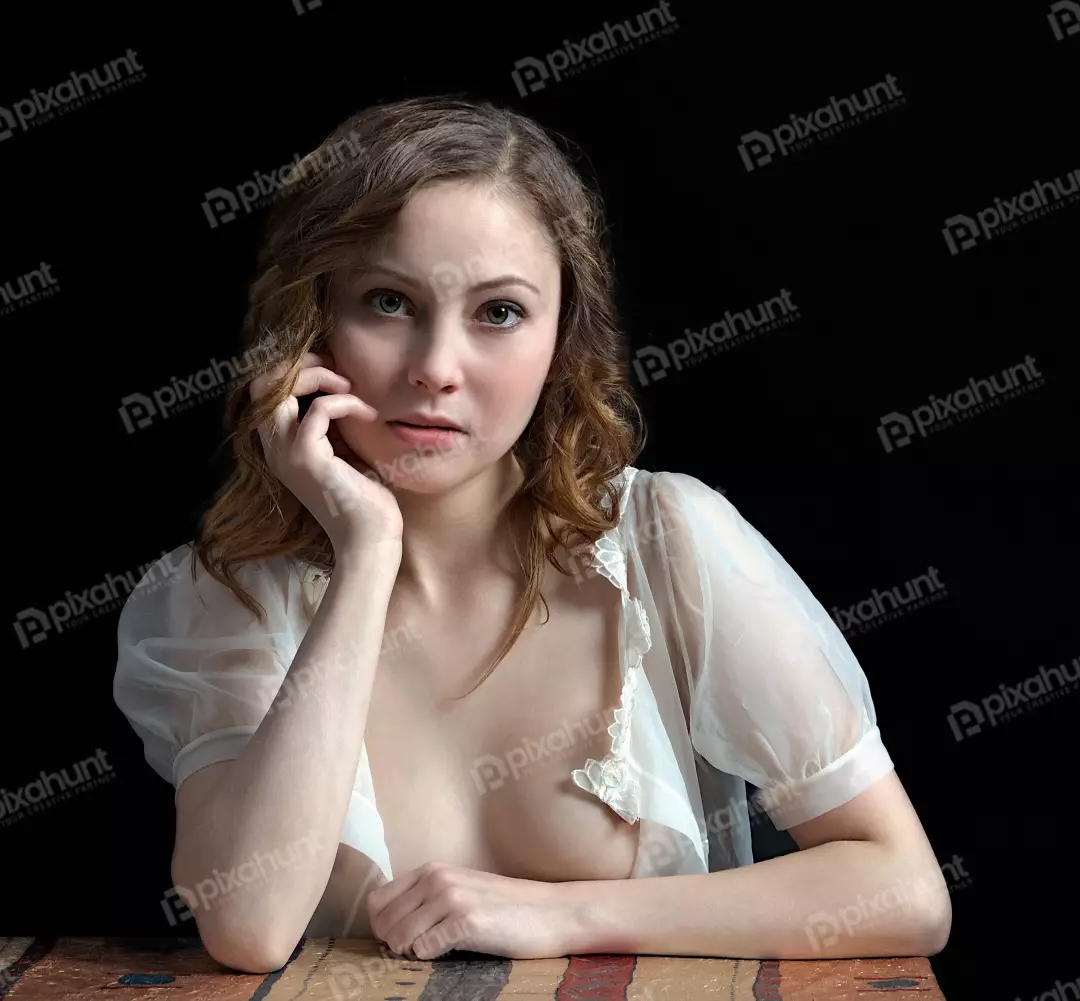 Pensive Young Woman in Sheer White Blouse Gazing with Expressive Eyes