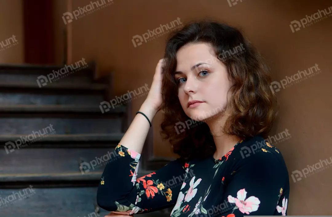 Pensive Young Woman with Curly Brown Hair and Striking Blue Eyes