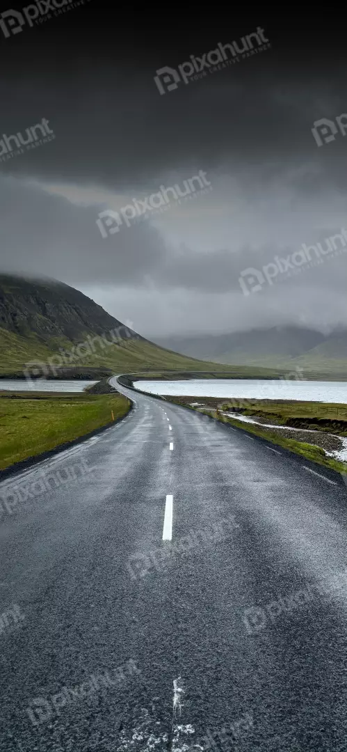 Free Premium Stock Photos Empty scenic asphalt road winding through a dramatic Icelandic landscape under moody skies