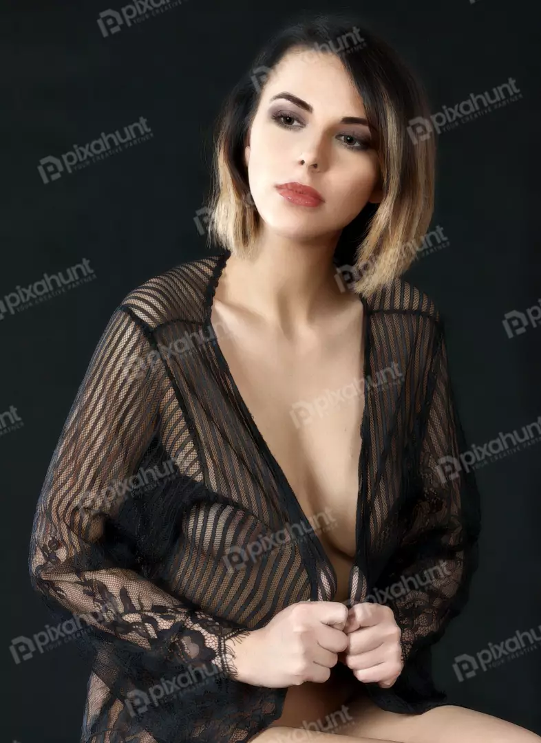 Alluring Woman in Sheer Black Lace Robe with Striking Hairstyle Studio Portrait