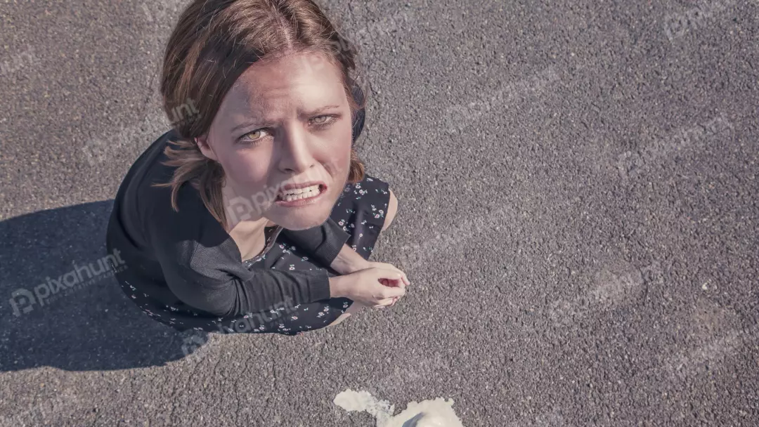 Young Woman Reacting with Extreme Disgust to Spilled Ice Cream on Asphalt