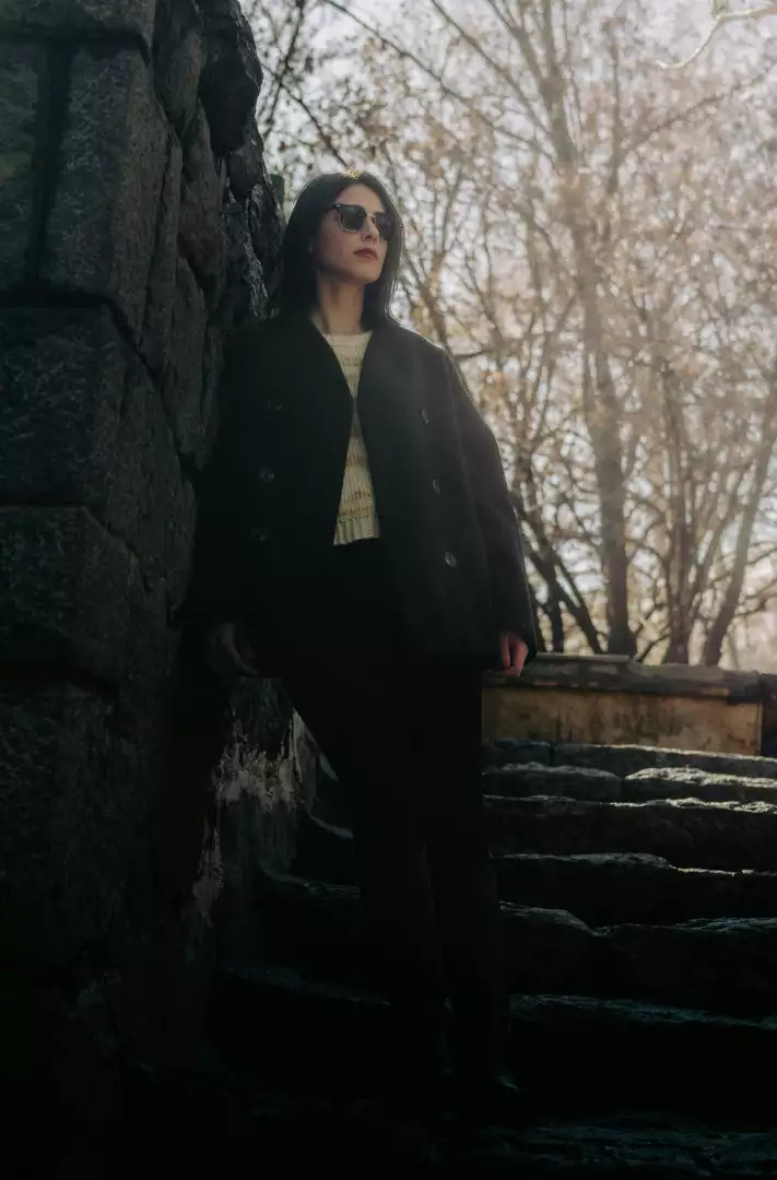 Free Premium Stock Photos Fashionable Woman Posing Confidently by Stone Wall and Steps in Autumn