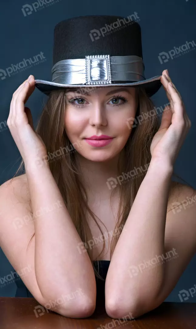 Young Woman Posing Playfully with Black Top Hat and Silver Band