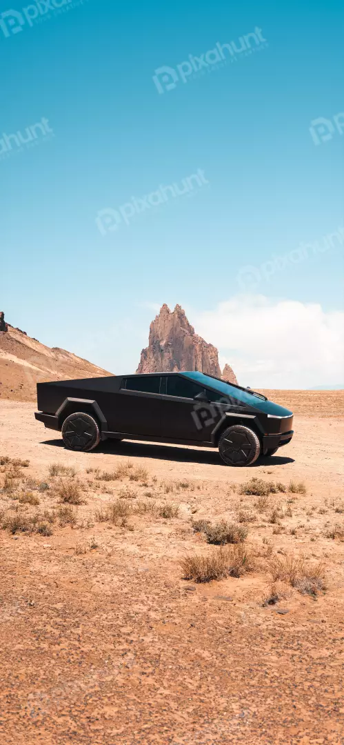 Sleek Black Tesla Cybertruck in Arid Desert Landscape Under Clear Sky