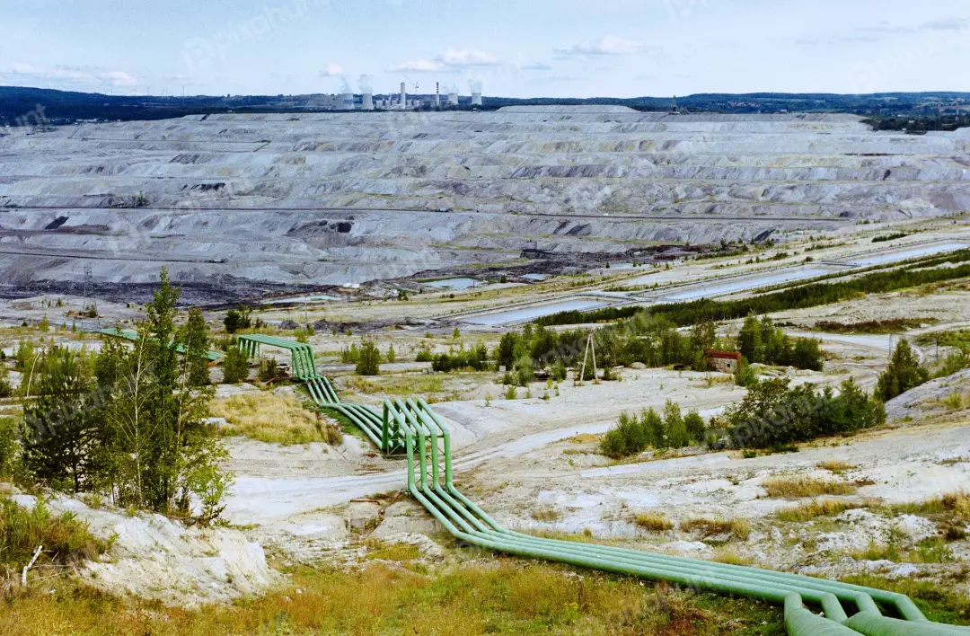 Massive Open-Pit Mine and Industrial Power Plant Landscape with Green Pipelines