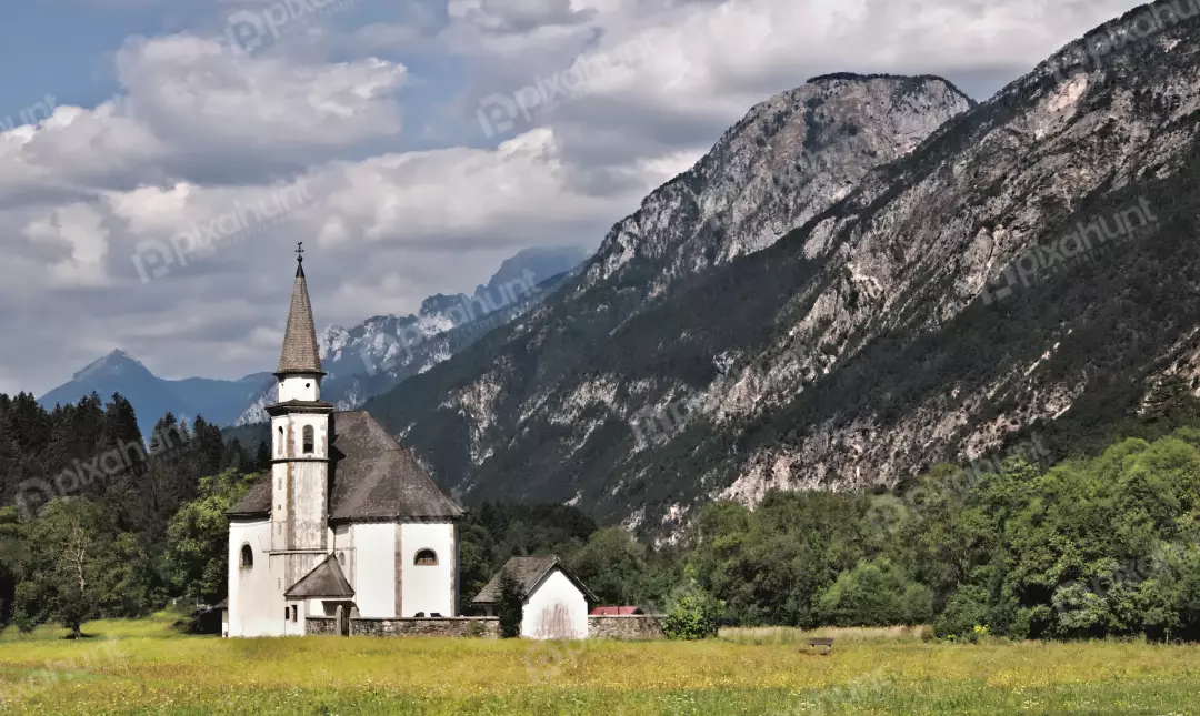 Historic Alpine Church in Lush Mountain Meadow Landscape