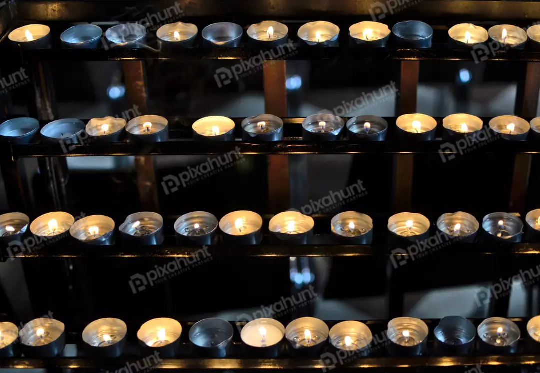 Rows of Glowing Votive Candles in a Dark Spiritual Setting