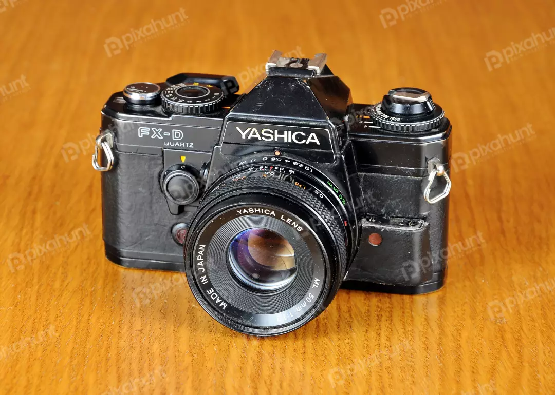 Vintage Yashica FX-D Quartz 35mm SLR Film Camera on Wooden Background