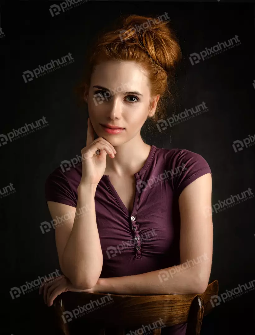 Pensive Redhead Woman with Messy Bun in Thoughtful Studio Portrait