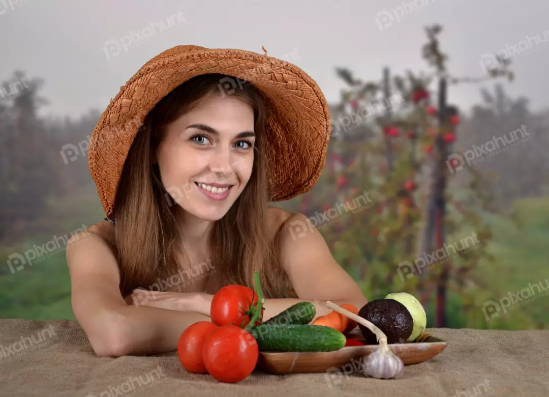 Smiling Young Woman in Straw Hat with Fresh Garden Harvest