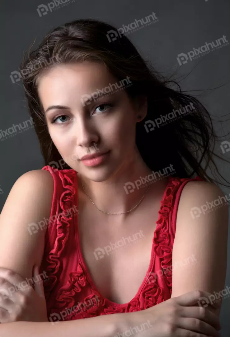 Captivating Young Woman with Windblown Hair and Pensive Gaze