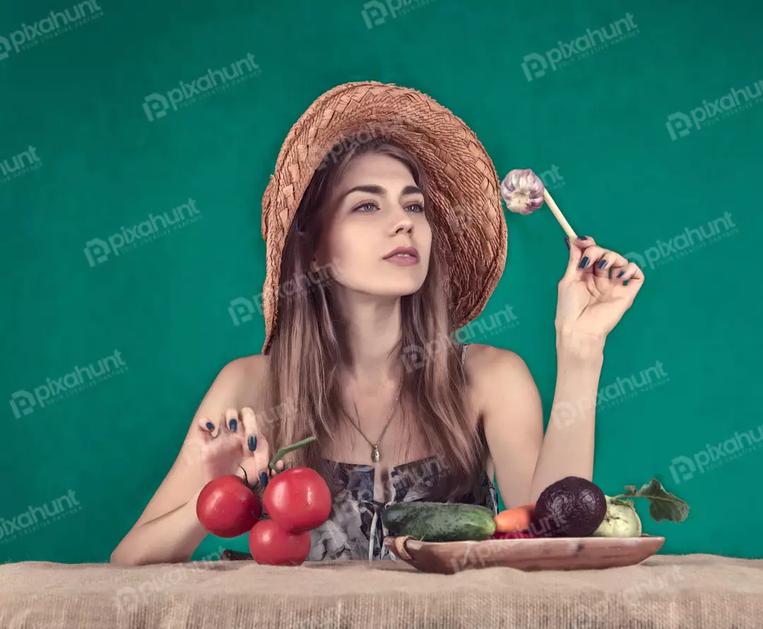 Young Woman in Straw Hat Pondering Garlic Amidst Fresh Vegetables