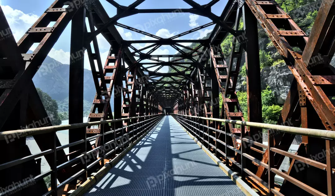 Historic Rusty Metal Truss Bridge Pathway Through Green Mountain Valley