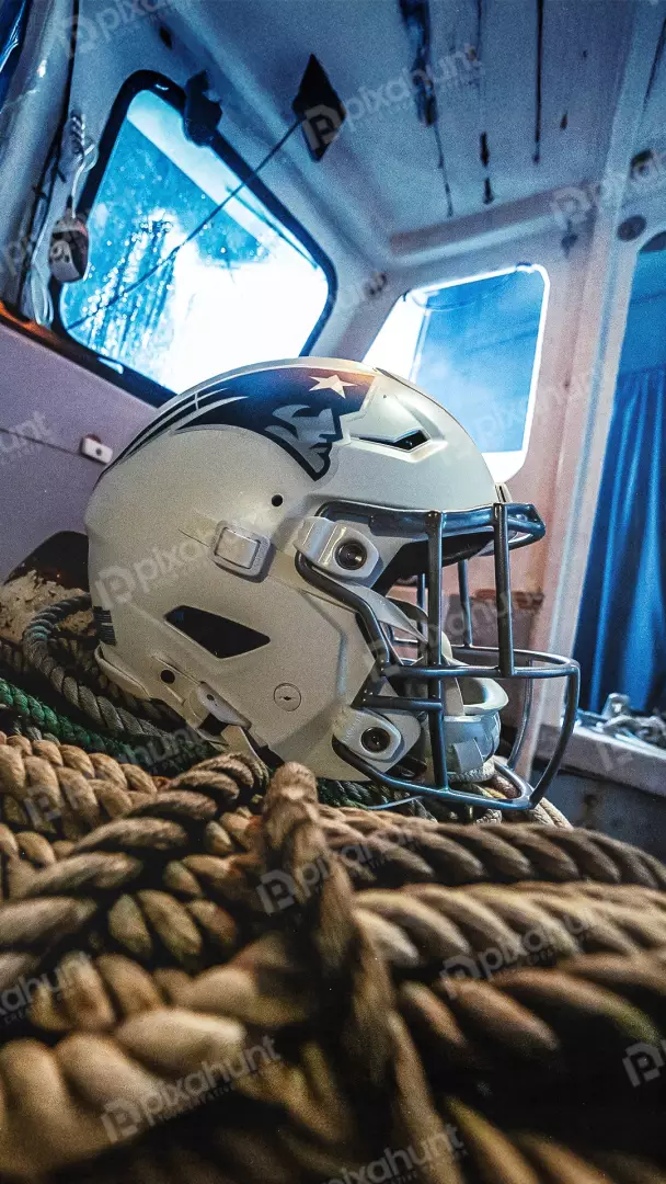Free Premium Stock Photos New England Patriots Football Helmet Resting on Nautical Ropes in a Boat Cabin