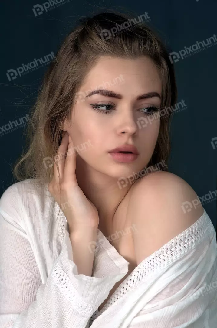 Pensive Woman in White Crinkled Off-Shoulder Top Portrait