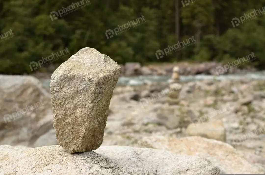 Balanced Stone Cairn by Mountain River Landscape