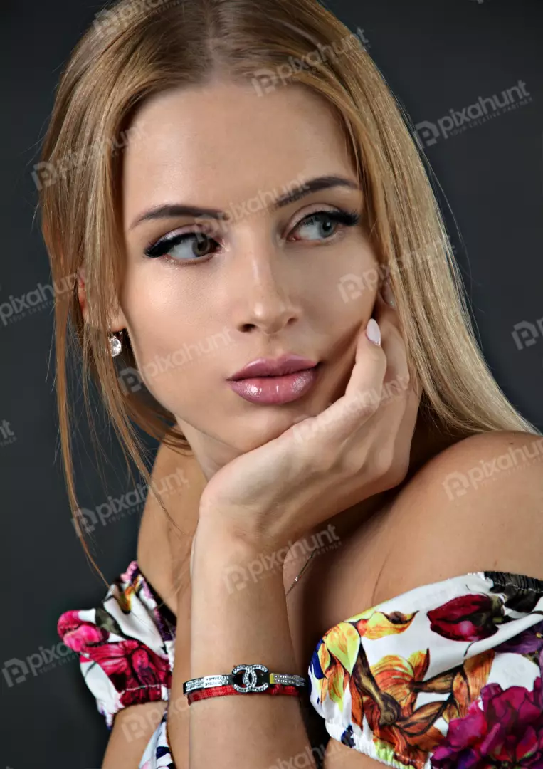 Elegant Blonde Woman Posing in Floral Top with Pensive Expression