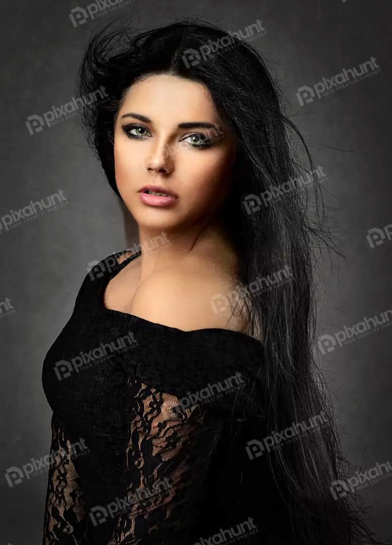 Captivating Woman with Windswept Dark Hair and Green Eyes